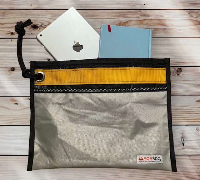 LIGHT THROUGH Clutch silver/black color. Sustainable, versatile and waterproof. Store your documents, your cables, your iPad mini or use it as a toiletry bag.